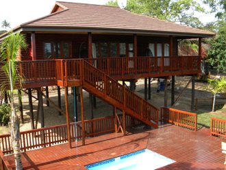 A house on stilts with an elevated view over a Litchi farm in St Lucia