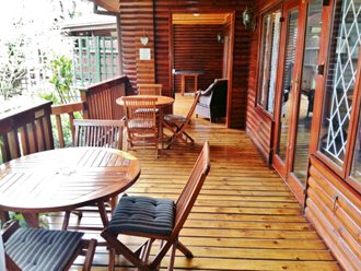 A LARGE, COVERED AND EXTENSIVE DECK WITH SEATING