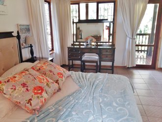 Bedroom With Views And Door Leading Onto The Covered Deck
