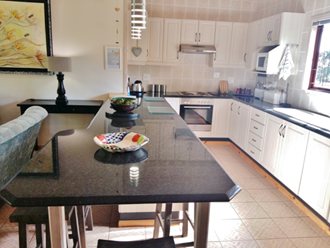 Modern Kitchen, Granite Tops And Pendulum Lights