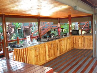 Open kitchen with roll-down canvas screens at a tented camp in St Lucia