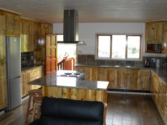 This kitchen was made from timber sourced on a farm. Beautiful island with cookerhood